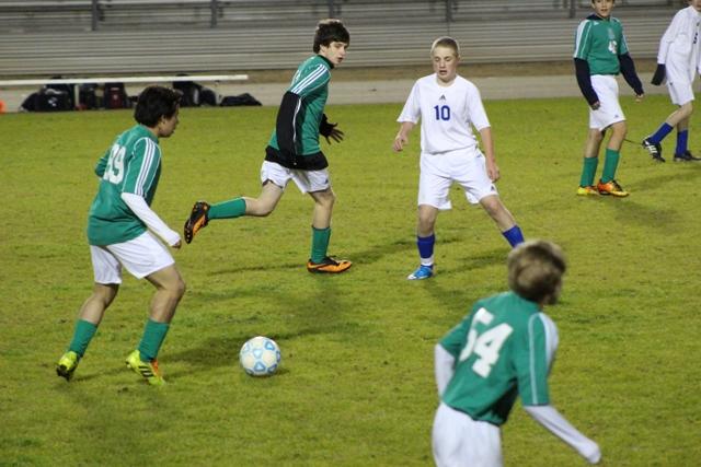 The boys freshman team playing when the weather was cold not rainy