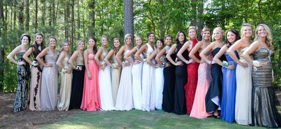 A group of senior girls take photographs together before boarding the party bus for prom last year. 