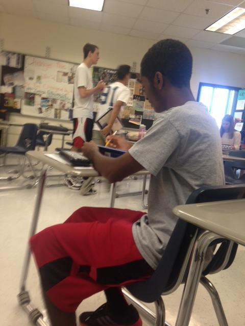 Senior Joel Page finishes his homework during class.
