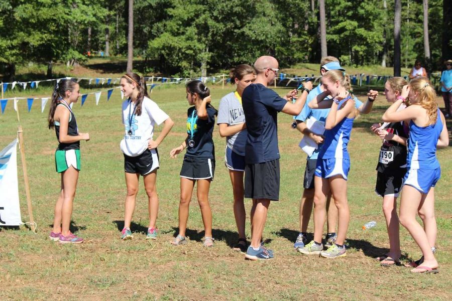 Alan Webb hands out medals at the Panther Cross Country Invitational. Sophomore Rachel Ward is the left-most runner pictured. 