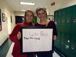 Juniors Kyleigh Mattingly and junior Emily Russell hold up their bucket list goals: travel. 
