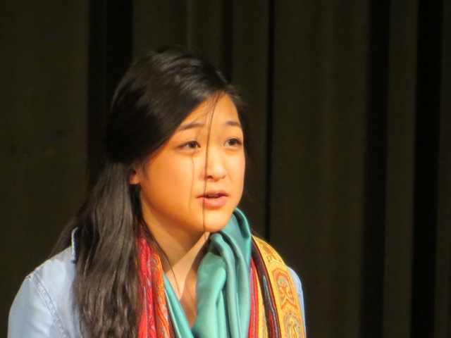 Sophomore Joie Zhou performs her poem "The Lamb" by Linda Gregg, a poem depicting those affected by war as lambs.