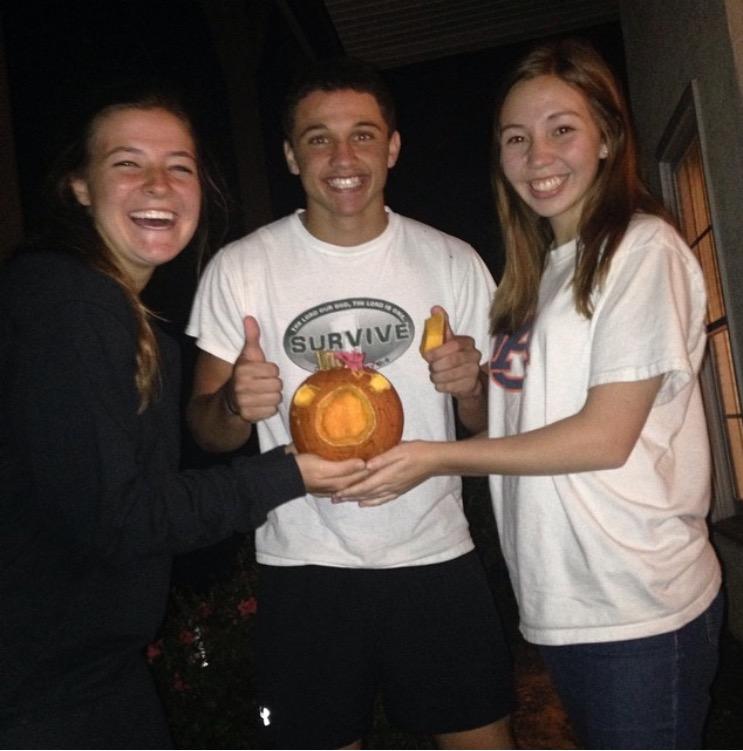 Seniors+Jackie+Gray+%28left%29%2C+Josh+Ange+%28middle%29%2C+and+Jen+Koval+%28right%29+pose+with+a+carved+miniature+pumpkin+from+Halloween.