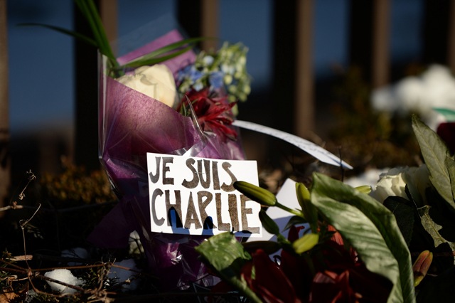 Flowers are left with notes written in French reading 'I am Charlie' and "rest in peace" near the fence at the French Embassy over a flower memorial January 8, 2015 in Washington, D.C., in response to the attack on satirical French magazine Charlie Hebdo by three gunmen yesterday that took the lives of 12 people. 