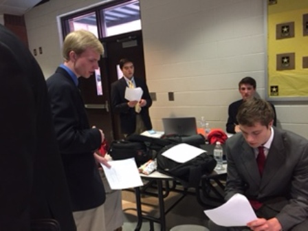 Debaters Stephen Black (Front Left), John Hamlin (Front Right), Christian Carr (Back Right), and Jackson Fuentes (Back Left) all prepare their statements.