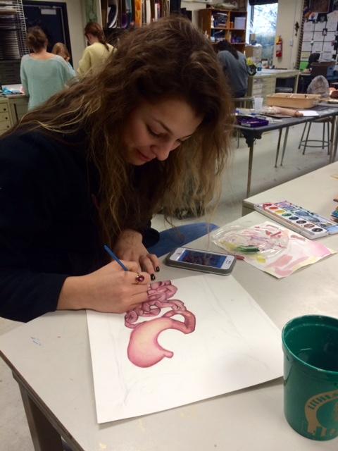 Junior Nicole Psomas finishes one of her twelve pieces before the deadline.