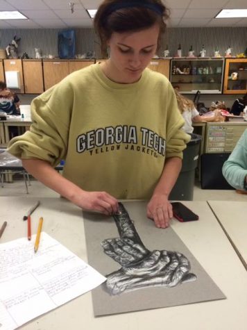 Junior Siena Dittrich working on her drawings focused on old people.