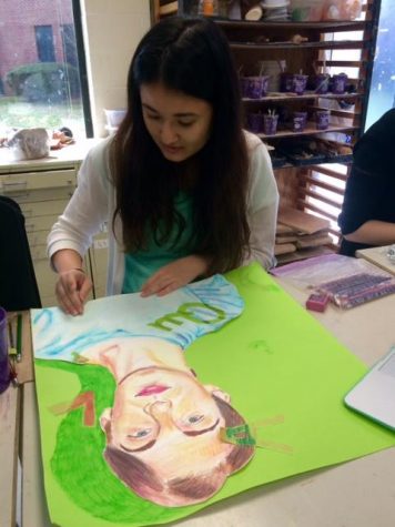 Senior Erika Gauvin working on her portfolio of students.