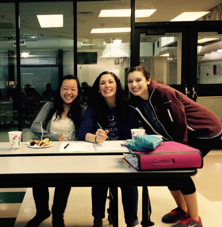 Council members Natalie Hung and Hope Didier help Latin Club students sign in before enjoying the food and games with Latin Club.