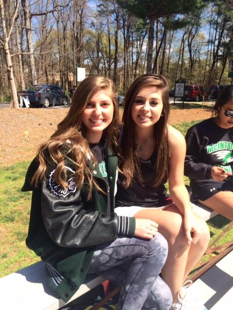 Sophomores Caroline Pickard and Natalie Dowling support the boys team between the girls' matches.