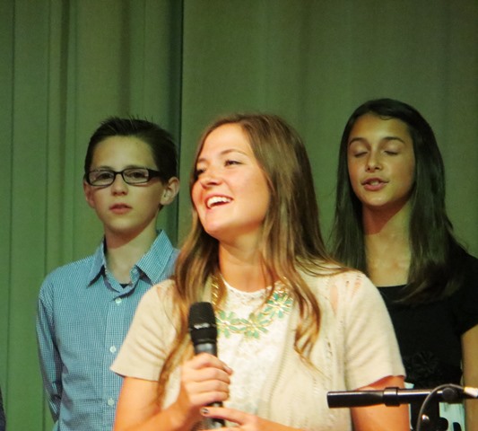 Senior Jackie Gray performs "Teach Me How to Dream." Ms. Angie Meredith, Mistress of Ceremonies, announced that the song will be featured in all future Teacher of the Year celebrations.