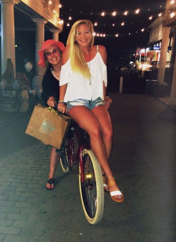 Seniors Rachel Massingill and Maddie O'Rourke ride bikes in the streets of Seaside. 