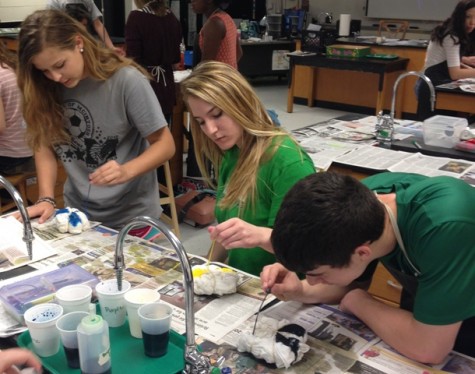 Sophomores Abby Burke, Meghan Schwinne and Jonathon Nase focus hard on making their t-shirts perfect.