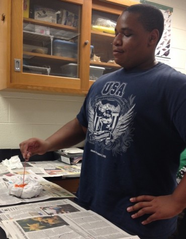 Sophomore Clay Wilson poses as he creates his t-shirt.