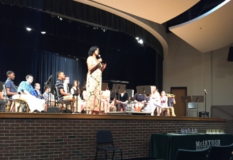 Ms. Baker introduces the first band to preform. 