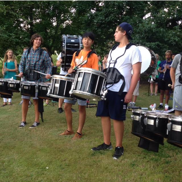 Drum line members juniors Daniel Lane and Seth Goss and senior Justin Hong perform fan favorite song, "Virus," at Chik Fi La pep rally.