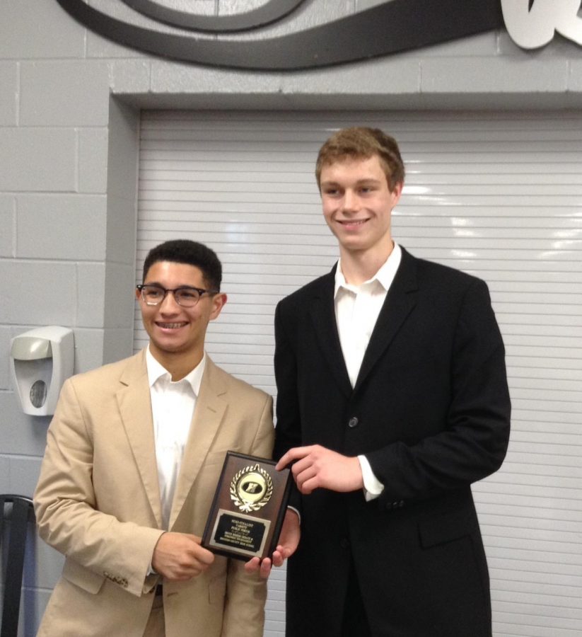 Debate president Andrew Alter (left) and vice president John Hamlin (right) hold their plaque for winning tournament semifinalists.