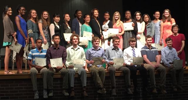 The new Mu Alpha Theta Honor Society inductees and officers pose alongside their sponsor, math teacher Linda Koroma.