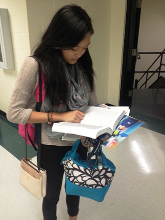 Junior Joie Zhou reviews her notes in preparation for the Socratic seminar.