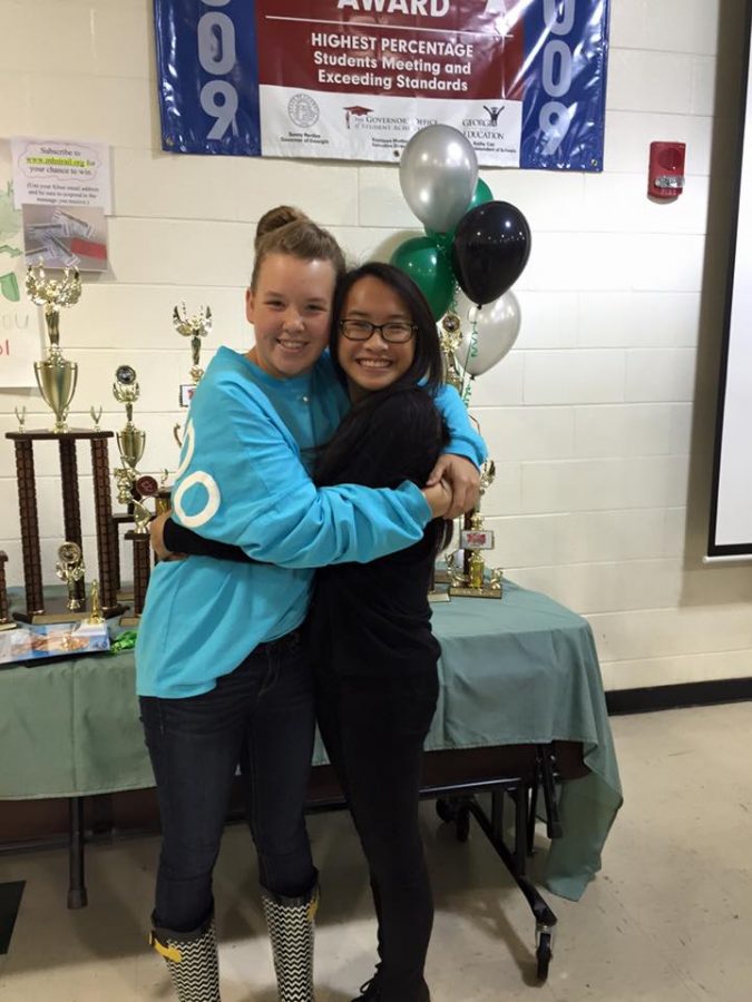 Senior Miykala Denison and junior Kaili Boyes share a heart felt moment at the 2015 band dinner.