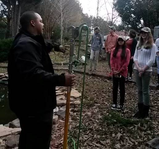 Arborist Nick Steward shows students how an arborist can cut high branches.