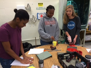 Junior Jalin Walters, sophomore Amber Galloway and junior Hannah Wilde print their block art.