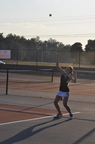 Junior Caroline Pickard hits a serve during her doubles match with junior Natalie Dowling against Northgate.