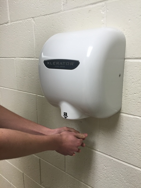 A+student+uses+the+new+hand+dryers+in+the+bathrooms+located+in+the+main+hallway.