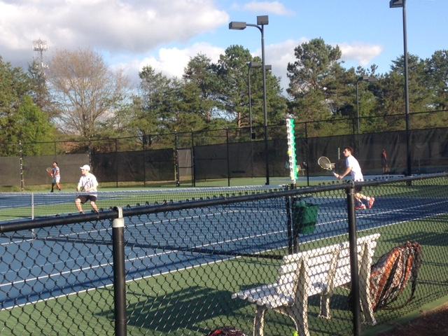 The+varsity+tennis+team+warms+up+before+a+match.+The+Chiefs+went+1-2+in+the+tournament.