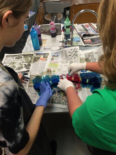 Ms. McMahon helps sophomore Daniella Haas tie-dye her t-shirt. 
