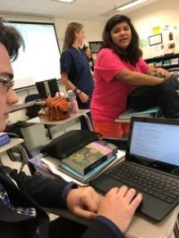Students Gisselle Roman and Jacob Mewborn are pictured searching for and discussing scholarship opportunities.