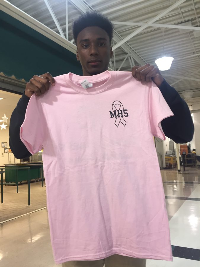 Student Junior Deandre Wade sells breast cancer awareness shirts in order to raise awareness of the disease.