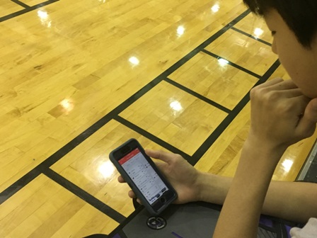 Freshman Tony Liu checks his bracket after the first day of NCAA tournament games.