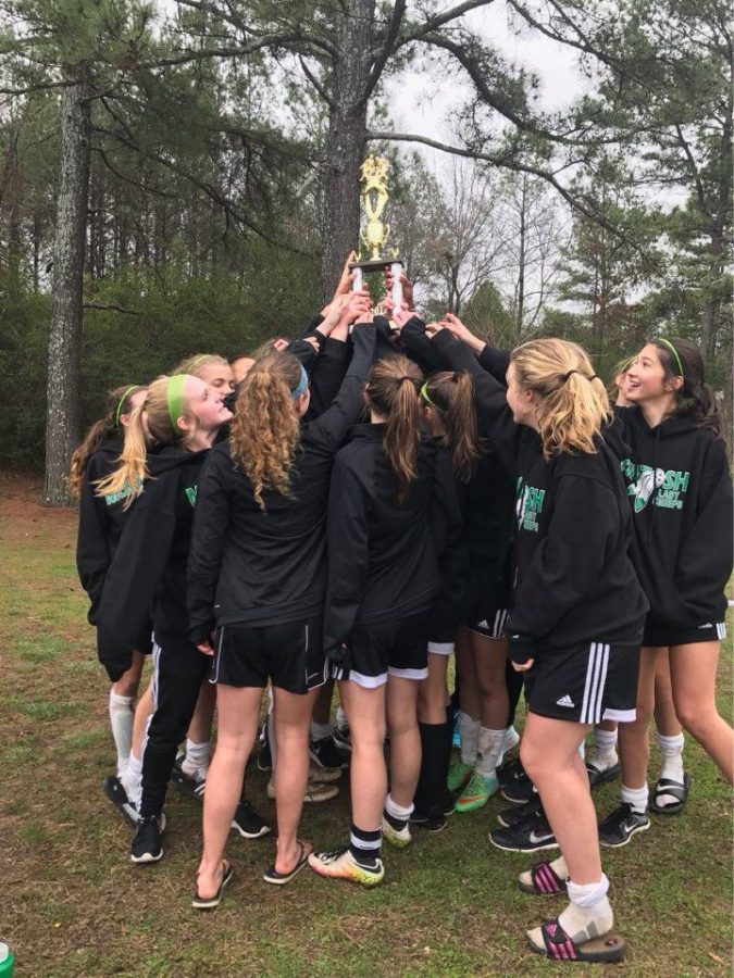 The girls team celebrates their victory after their games on Saturday, March 11.