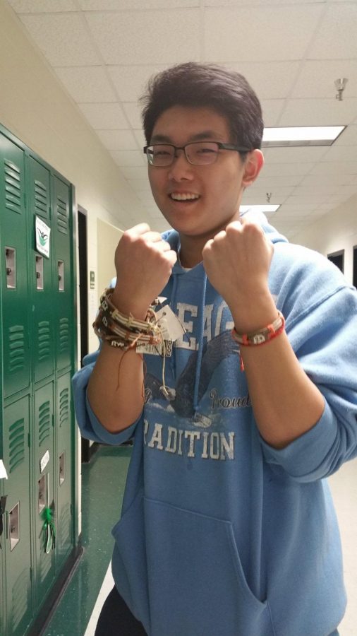 Junior Arik Li fights off poverty by selling Yuda bands.