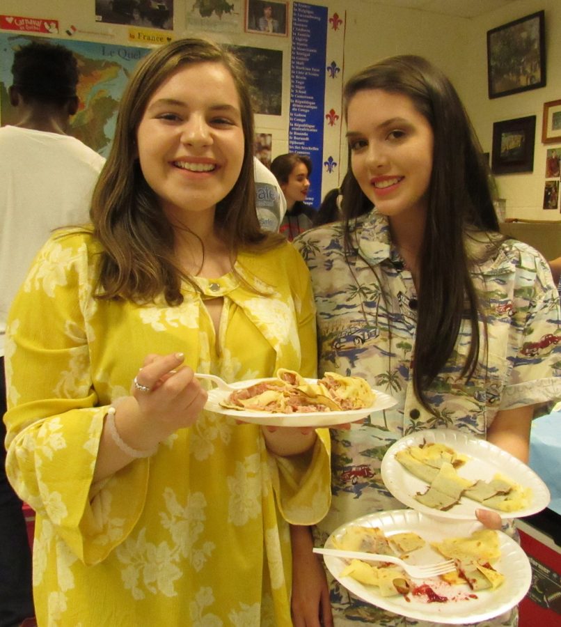 Senior Lee Newton and Junior Jayna Lobl enjoy some of their favorite foods for Food Friday during Foreign Language Week.