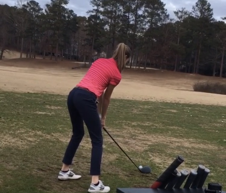 Claire+Walker+practices+her+golf+swing.