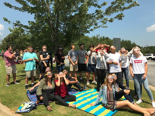 Ms.+Bowles+class+watches+the+eclipse+from+the+front+parking+lot+of+McIntosh+High+School