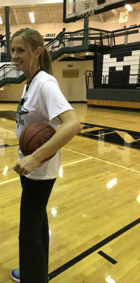 Ms. Carlyle smiles for the camera at a recent basketball practice.