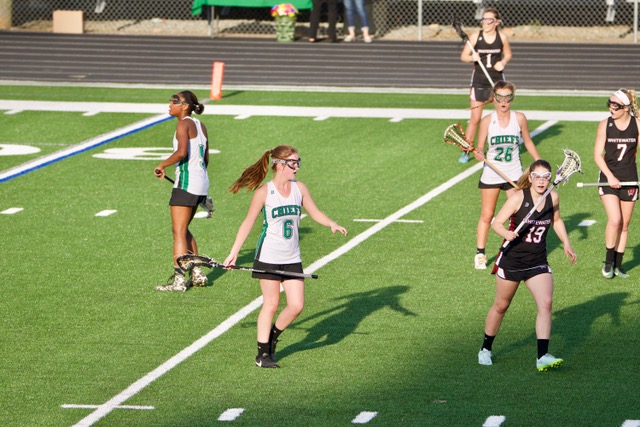 Marie Ogletree and the varsity Lady Chiefs lacrosse team playing against the Whitewater Wildcats. 