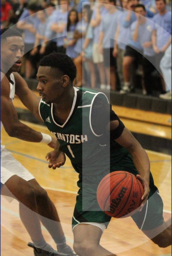 Senior Bruce Carpenter dribbles past a defender while Starrs Mill students yell in the background. Photo courtesy of Chris Dunn.