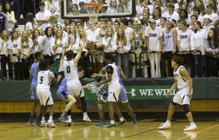 Those in the student section encourage McIntosh players to steal the ball from the Starrs Mill player.