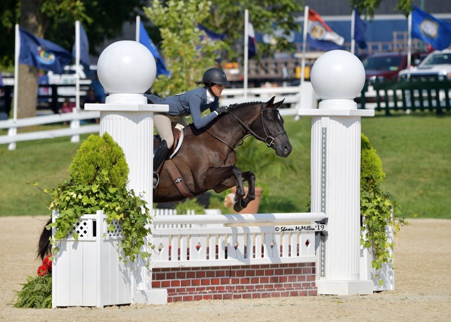 Abby Rauch mid jump at one of her horse shows. 