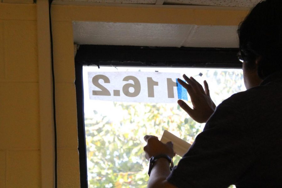 Room number being placed on a window 