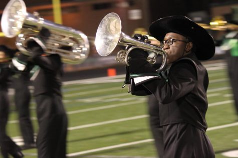 MHS Marching Band member sophomore Adeola Batiste practices for the performance that was rained out. 