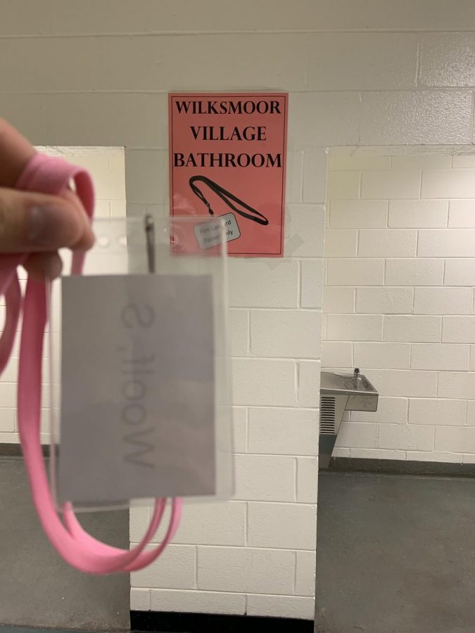 The pink lanyard that corresponds to the downstairs Wilksmoor hallway- students going to the bathroom from this hall must go to this location. 