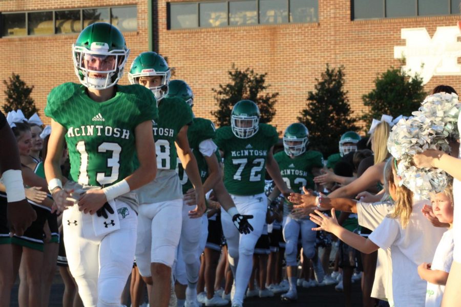 Junior, Porter Frank leads the team out of the locker room to take the field at game time