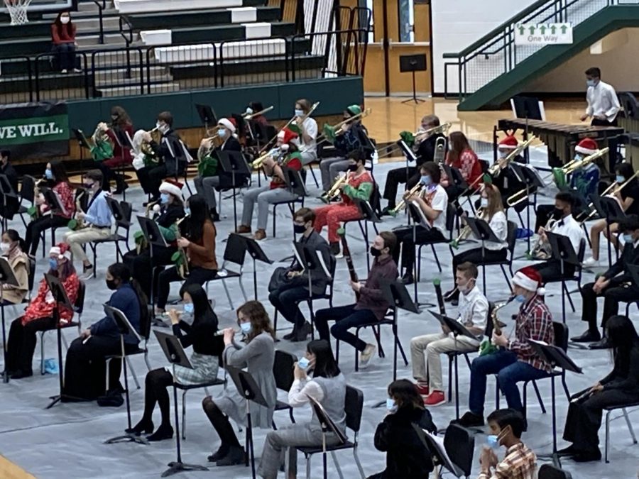 Band students are distanced while playing at their Christmas concert. They play with bell covers to help stay within the regulations of covid.