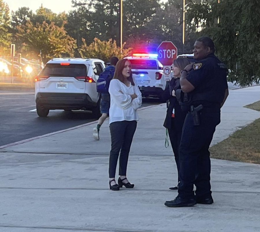 Added police presence at MHS the morning of Oct. 6, 2022, as teacher Brooke Lloyd, Principal Maggie Walls and SRO Brandon Weathersby  and  talking outside the Media Center doors at the front of the school 