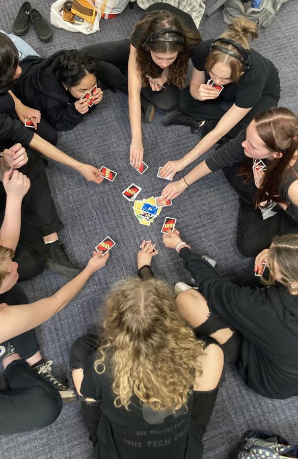 The cast and crew of the one act play the card game UNO before they perform